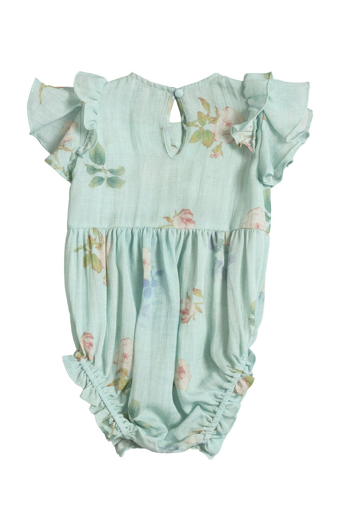 The Baby Hattie Romper in Roselyn Blue by Ivy City Co features flutter sleeves, a keyhole button at the back, and a soft floral print. The fabric gathers at the waist and leg openings for a ruffled, playful look—perfect for a sweet mommy-and-me outfit.