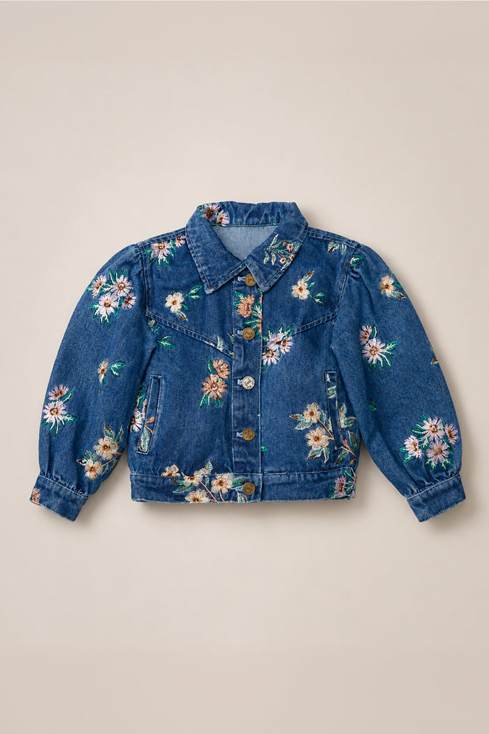 The Mini Posey Denim Jacket in Lovelorn Ditsy Embroidery by Ivy City Co features a collar, long sleeves, and front buttons, adorned with a colorful floral embroidery pattern. This girls’ denim jacket combines classic style with playful charm, making it a standout piece for any wardrobe.