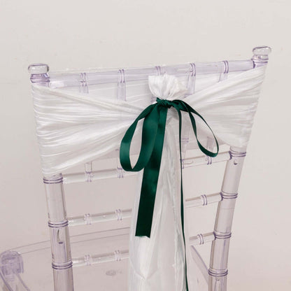 Clear chiavari chair with white satin ribbon and green bow.
