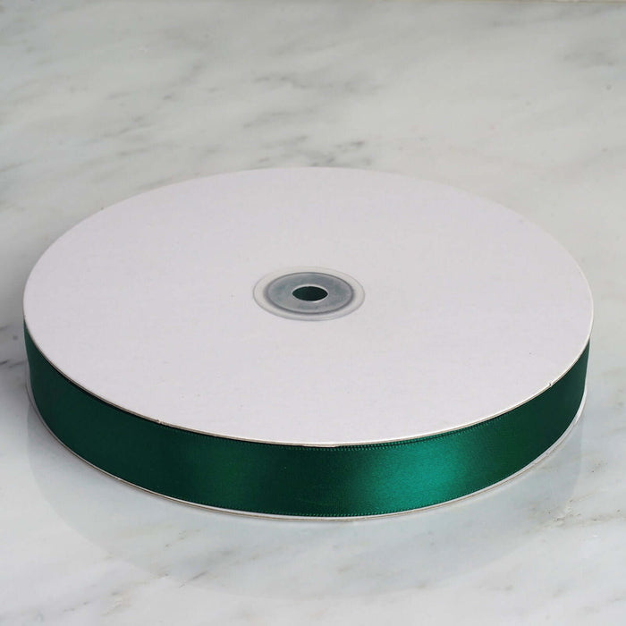 Green satin ribbon spool on white background #whtbkgd
