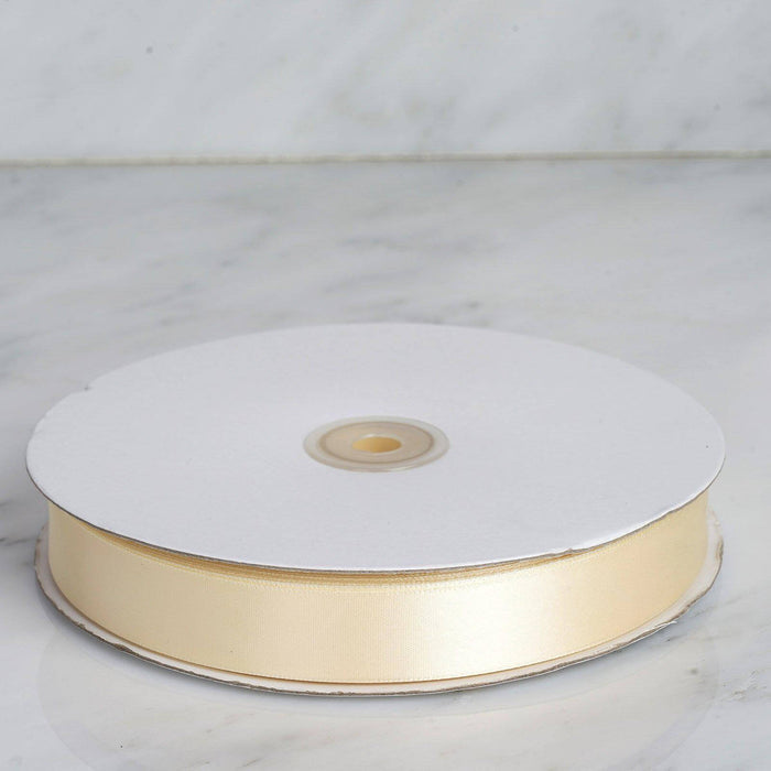 Pale gold ribbon on a spool against a marble background #whtbkgd