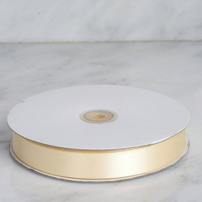 Pale gold ribbon on a spool against a marble background #whtbkgd