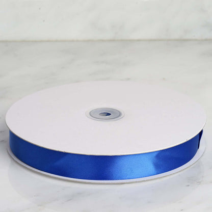 Blue satin ribbon on a roll against a marble background. #whtbkgd