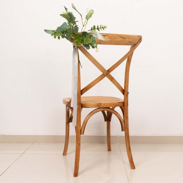 Wooden cross-back chair with floral decoration on the back