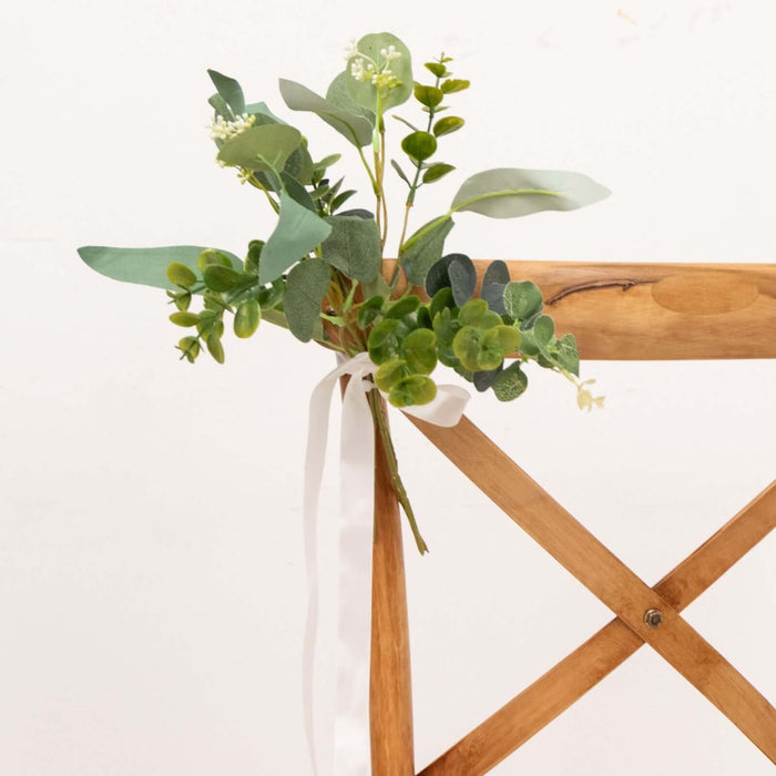 Eucalyptus and greenery bouquet tied with a ribbon on a wooden chair