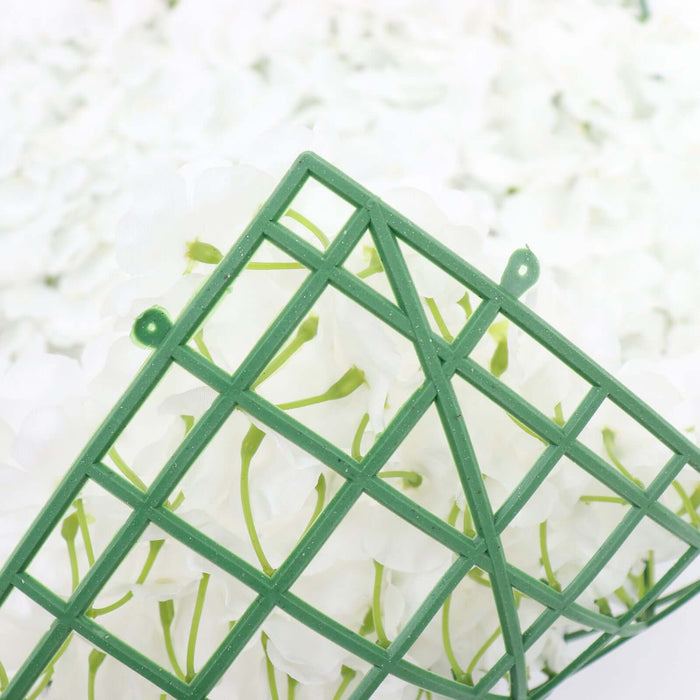 Green floral foam holder with white artificial flowers
