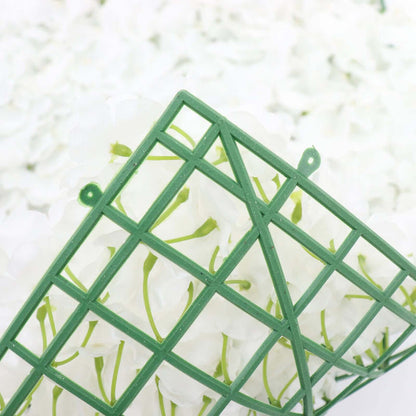 Green floral foam holder with white artificial flowers