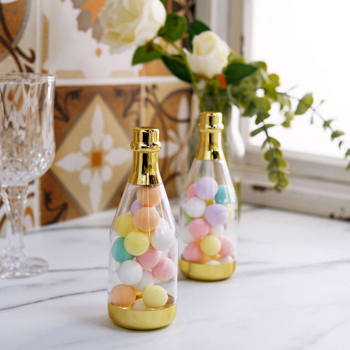 Colorful candy-filled glass bottles with gold accents on a marble surface.