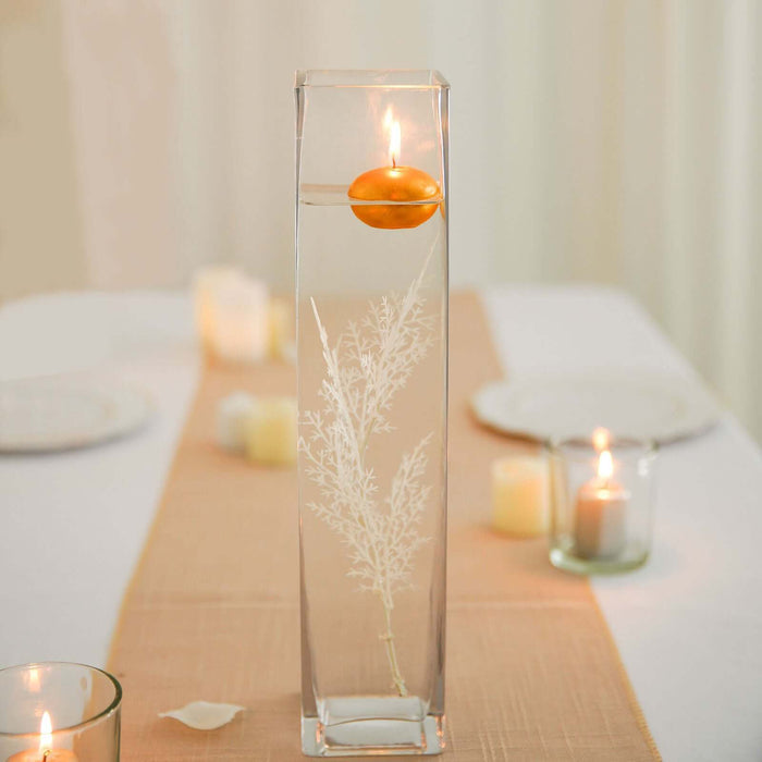 Elegant glass vase with floating candle and decorative foliage