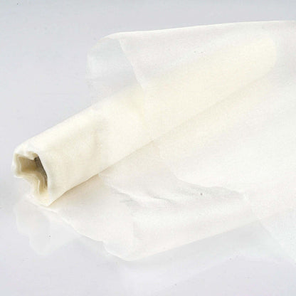 Sheer white fabric roll on a plain background