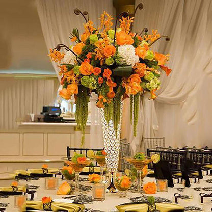Tall floral arrangement with orange and white flowers in an elegant vase.
