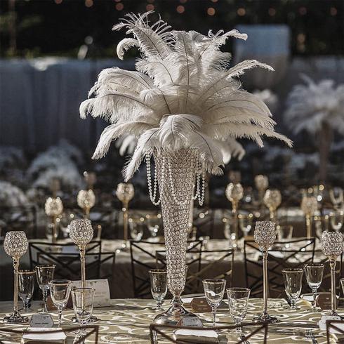 Elegant white feather centerpiece with crystals on a beautifully set dining table.