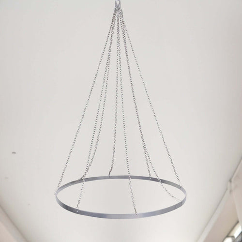 Modern circular chandelier with silver chains hanging from the ceiling