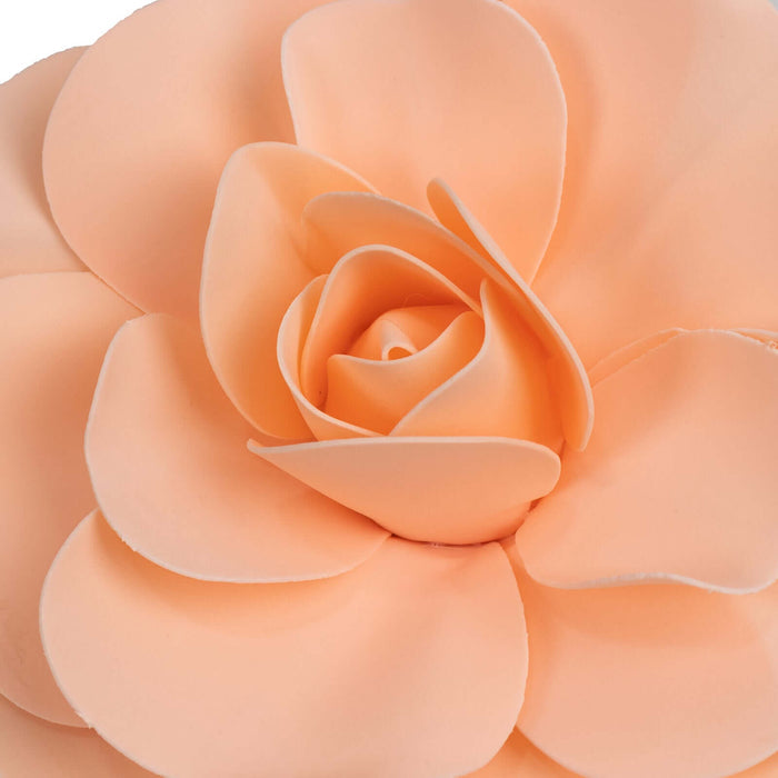Peach-colored flower decoration with layered petals.
