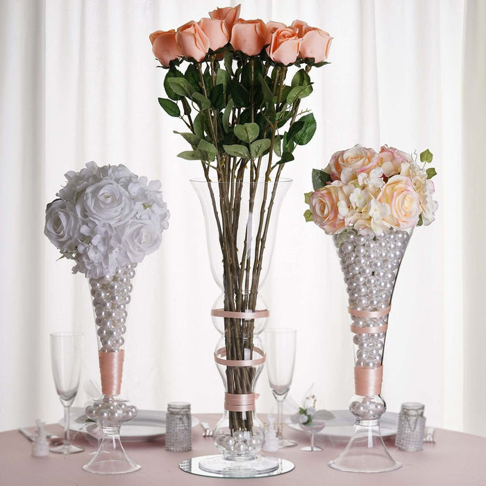 Elegant floral arrangements in crystal vases for wedding decor.