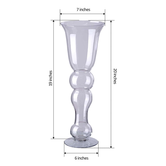 Clear glass vase with a decorative shape, 20 inches tall, 7 inches wide.