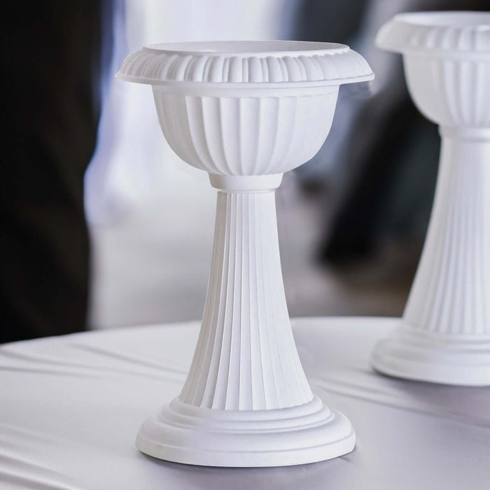 White decorative pedestal stand for events and displays.