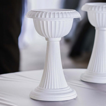 White decorative pedestal stand for events and displays.