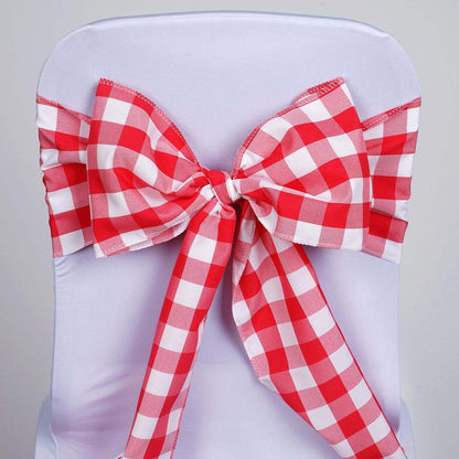 Red and white checkered chair sash bow on a white chair cover.