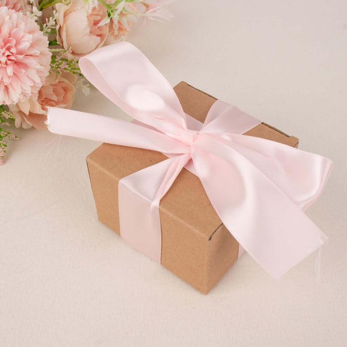 Gift box with pink ribbon on a neutral background.