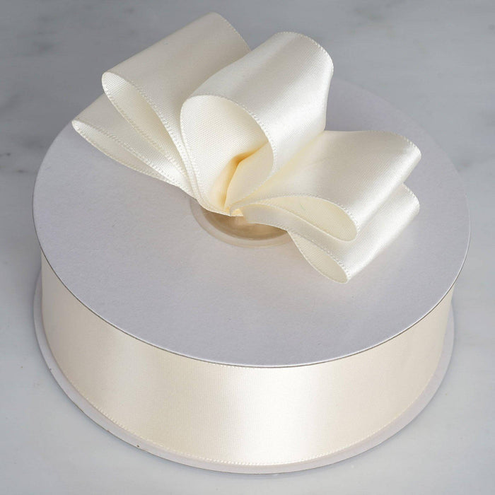 Cream ribbon with a bow on a round spool