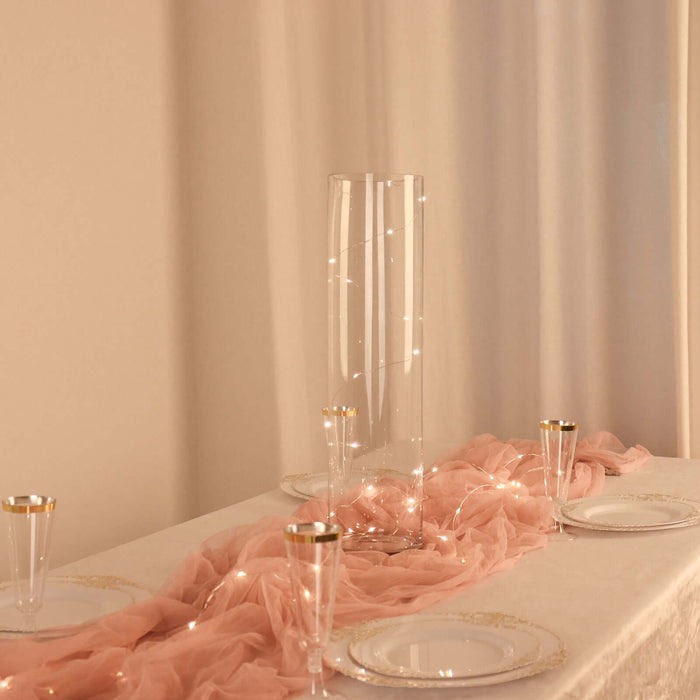 Elegant glass vase with fairy lights on a beautifully set table.