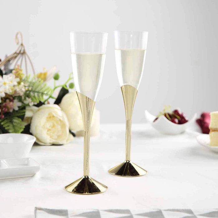 Elegant champagne flutes with gold accents on a table setting.