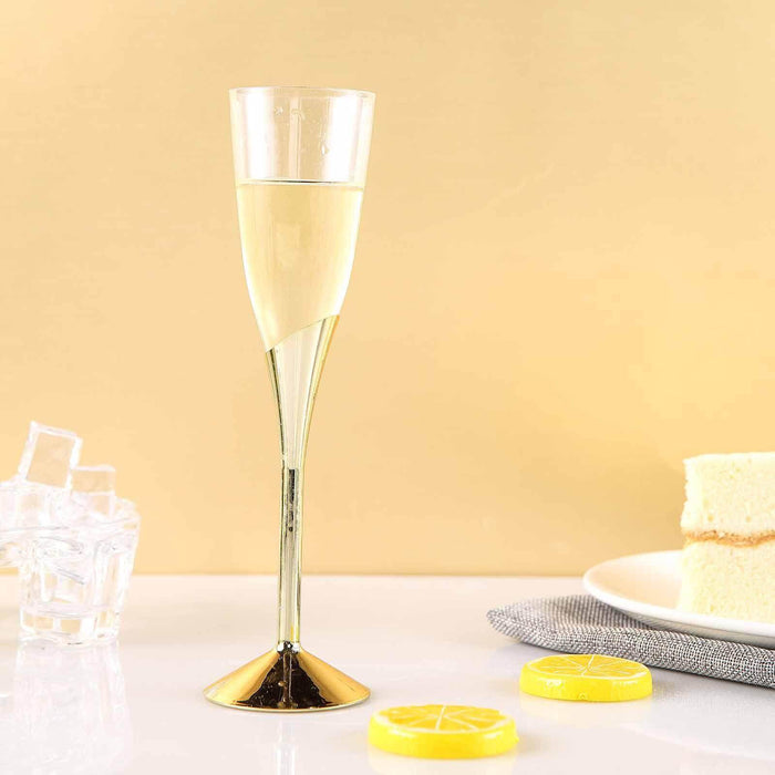 Elegant champagne flute with lemon candies and cake on a golden background.