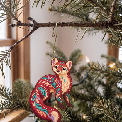 Laser-cut maple wood American Marten folk art ornament O264 hanging on a fir branch, made in USA