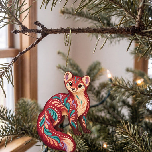Laser-cut maple wood American Marten folk art ornament O264 hanging on a fir branch, made in USA