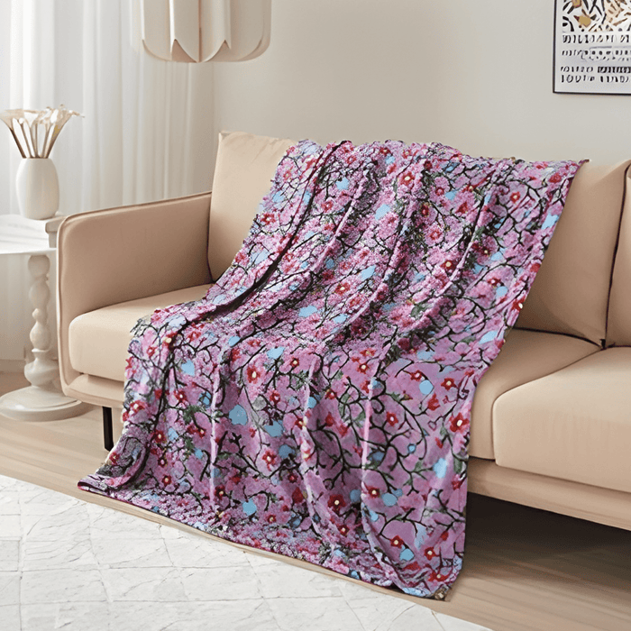 Anishinaabe Enchantment Throw Blanket draped on couch, showcasing colorful traditional designs for comfort and style.