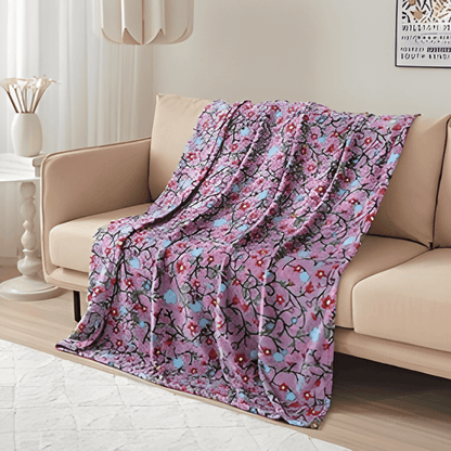 Anishinaabe Enchantment Throw Blanket draped on couch, showcasing colorful traditional designs for comfort and style.