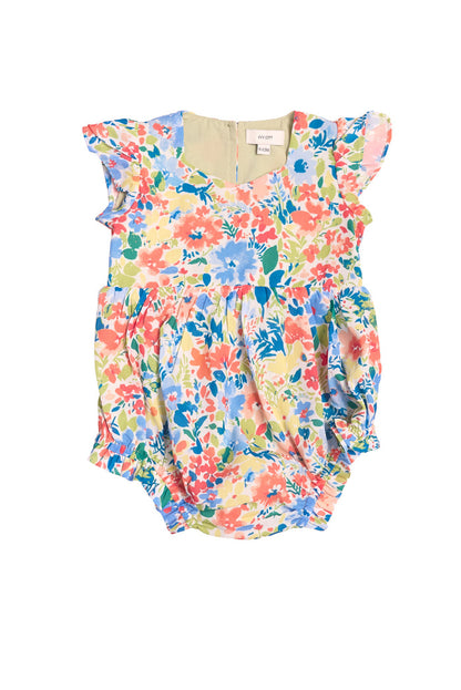 The Ivy City Co Baby Ada Romper in Vibrant Yarrow Print features blue, pink, yellow, and green florals, short ruffled sleeves, gathered leg openings, and soft lightweight fabric.