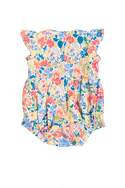 The Ivy City Co Baby Ada Romper in Vibrant Yarrow Print features ruffled sleeves and a bright floral design in pink, orange, blue, green, and yellow on a white background.