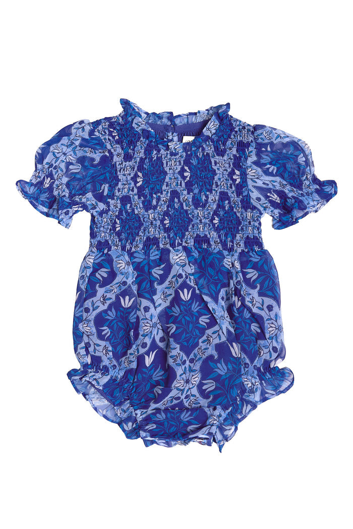 The Baby Cordelia Romper in Trellis Foulard by Ivy City Co features a smocked bodice, short ruffled sleeves, and a charming blue floral pattern—perfect for Easter. Elastic leg openings give this adorable outfit a cute, puffy look.