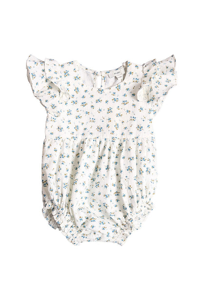 The Ivy City Co Baby Hattie Romper in Madeline Blue is an adorable white cotton baby romper adorned with a delicate blue floral print. It features short ruffle sleeves, a gathered waist, and elastic leg openings for comfort. Perfect as a special occasion baby outfit, this romper includes a classic button closure at the back and is shown on a white background.