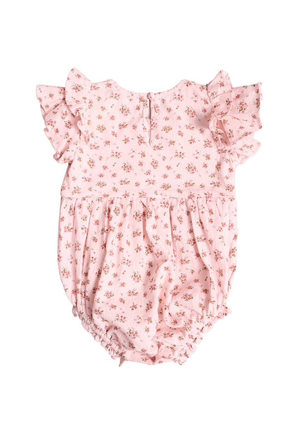 The Baby Hattie Romper in Madeline Pink by Ivy City Co features a sweet floral print, ruffled short sleeves, and an elastic waistband—ideal for a first birthday outfit and shown on a plain white background.