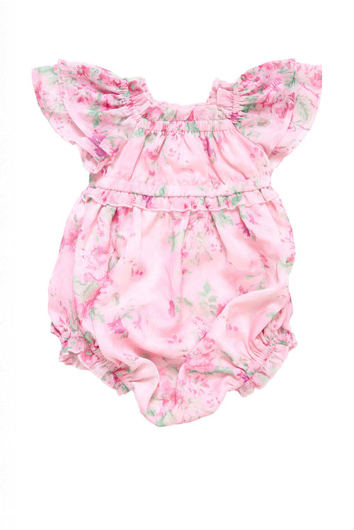 The Baby Juliana Romper in Rose Trance by Ivy City Co features a soft, ruffled pink floral print with green leaves, flutter sleeves, and an elastic waist—adorable for baby and perfect for a mommy and me look.