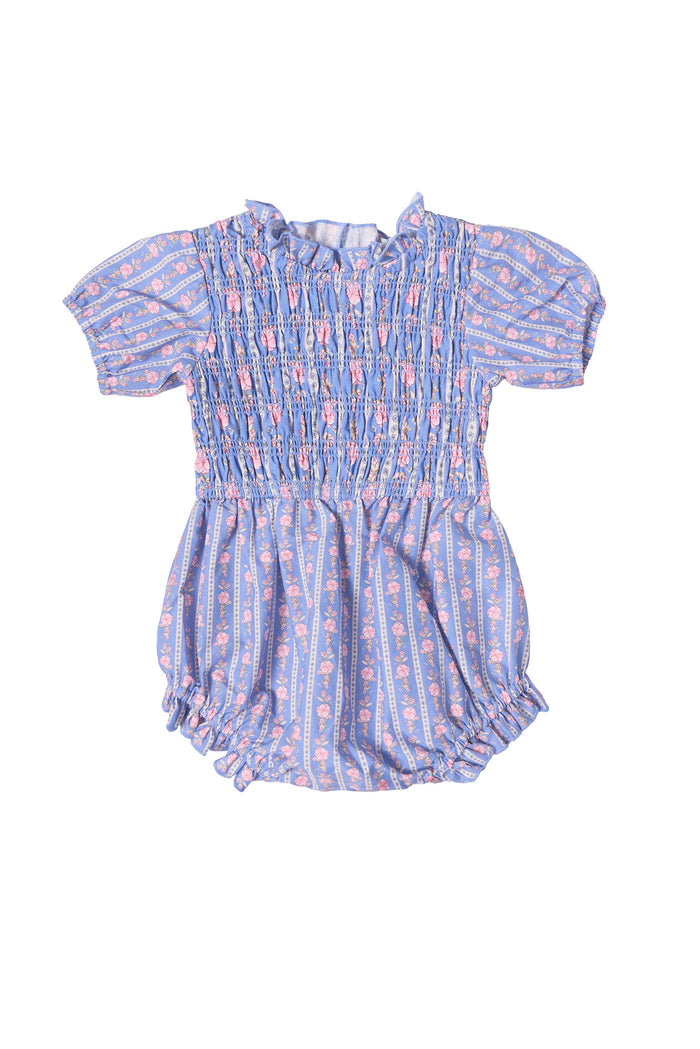The Ivy City Co Baby Mariah Romper in Linear Print has short sleeves, a ruffled neckline, gathered elastic at the waist and legs, and features light blue stripes with pink floral details.