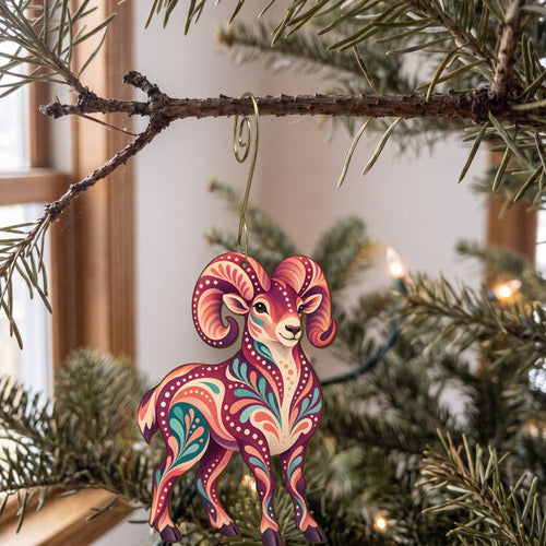Laser-cut maple wood Bighorn Sheep folk art ornament O244 hanging on a fir branch, made in USA