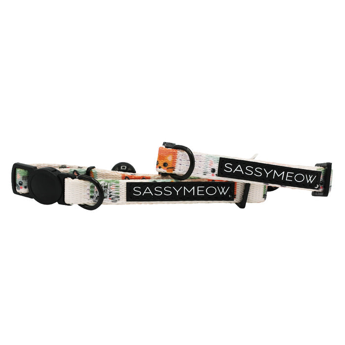 Two adjustable Sassy Woof Cat Collar - Smitten Kittens in white, featuring black buckles and a subtle multicolored pattern on comfortable neoprene fabric, each with a SASSYMEOW. label for added style.