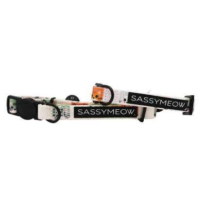 Two adjustable Sassy Woof Cat Collar - Smitten Kittens in white, featuring black buckles and a subtle multicolored pattern on comfortable neoprene fabric, each with a SASSYMEOW. label for added style.