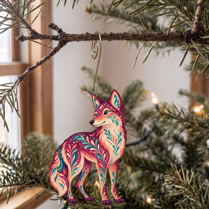 Laser-cut maple wood Coyote folk art ornament O252 hanging on a fir branch, made in USA