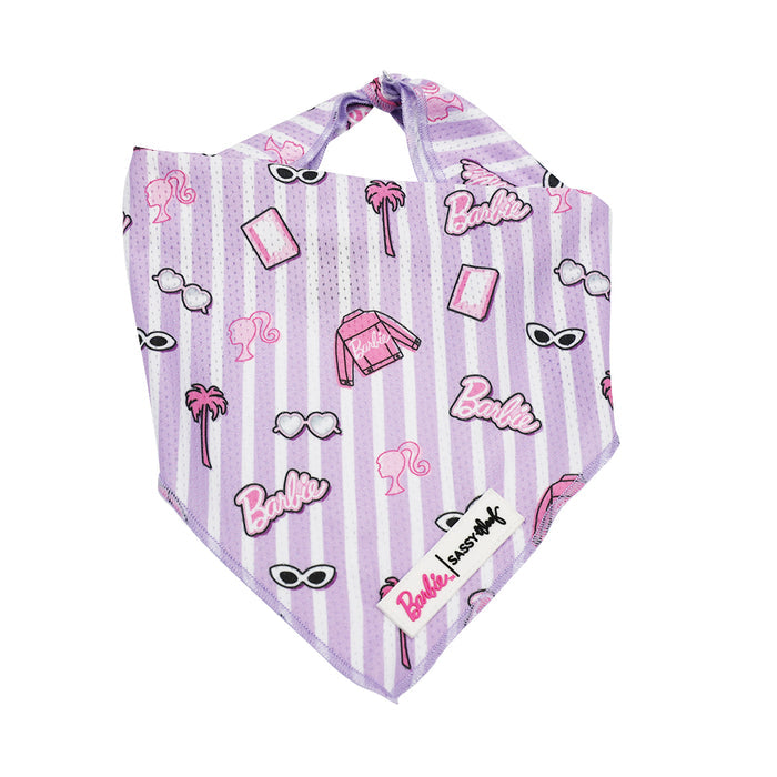 The Sassy Woof Dog Bandana - BARBIE™ Closet Goals, in pink and purple stripes with Barbie-themed illustrations, is shown laid flat on a white background.