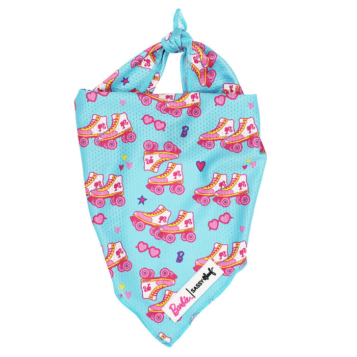 The Sassy Woof Dog Bandana - BARBIE™ On a Roll features blue mesh with roller skates, hearts, stars, a Barbie logo, a Susan G. Komen tag, and ties at the top—part of the Barbie x Sassy Woof collection.