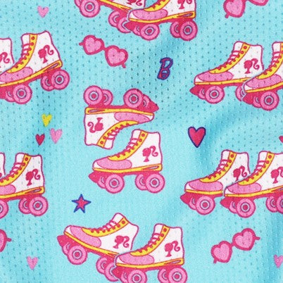 The Sassy Woof Dog Bandana - BARBIE™ On a Roll features pink and yellow roller skates with a "B" and 2, heart sunglasses, hearts, and stars on a light blue background from the playful Barbie x Sassy Woof collection.