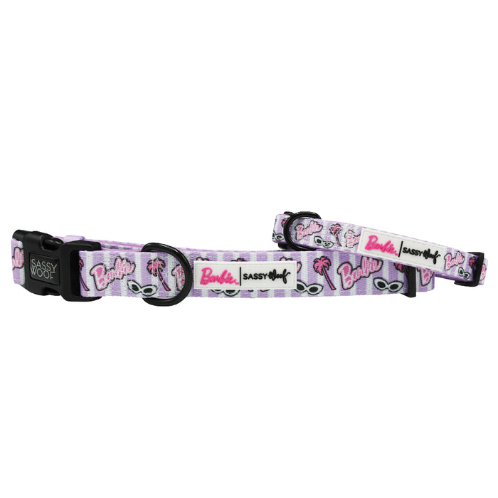 The Sassy Woof Dog Collar - BARBIE™ Closet Goals features a pink and white design with sunglasses, palm trees, and the Barbie logo. This adjustable collar includes black plastic hardware and displays the Sassy Woof brand name. Matching leash available.