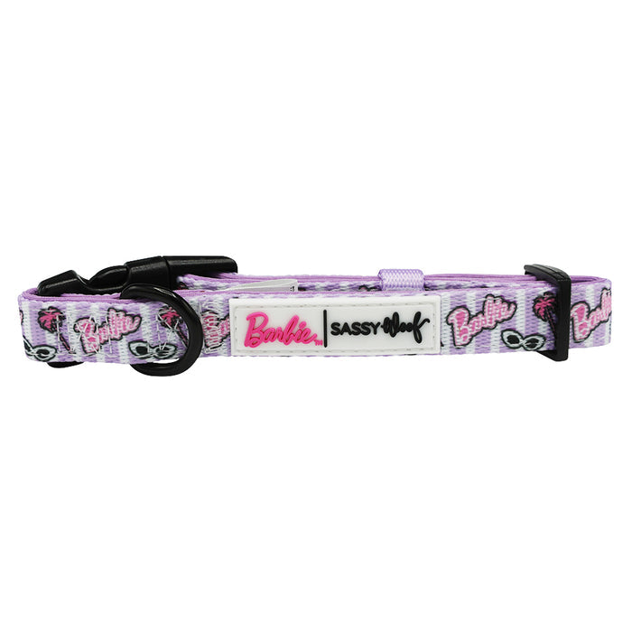 The Sassy Woof Dog Collar - BARBIE™ Closet Goals features pink and purple colors, Barbie logos, palm trees, sunglasses, black plastic buckles, and a “Sassy Woof” label—ideal for fans of the collection.