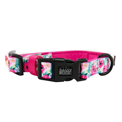 The Sassy Woof Dog Collar - Floral Frenzy features a floral pattern, pink inner lining, adjustable fit, black plastic buckle, and branded clasp—ideal to pair with your pet’s favorite reversible harness.