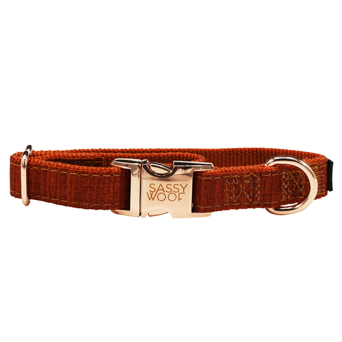 The Dog Collar - Foxy by Sassy Woof features a rust color, gold engraved buckle, matching gold hardware, and adjustable fit for style and comfort—all displayed against a white background.